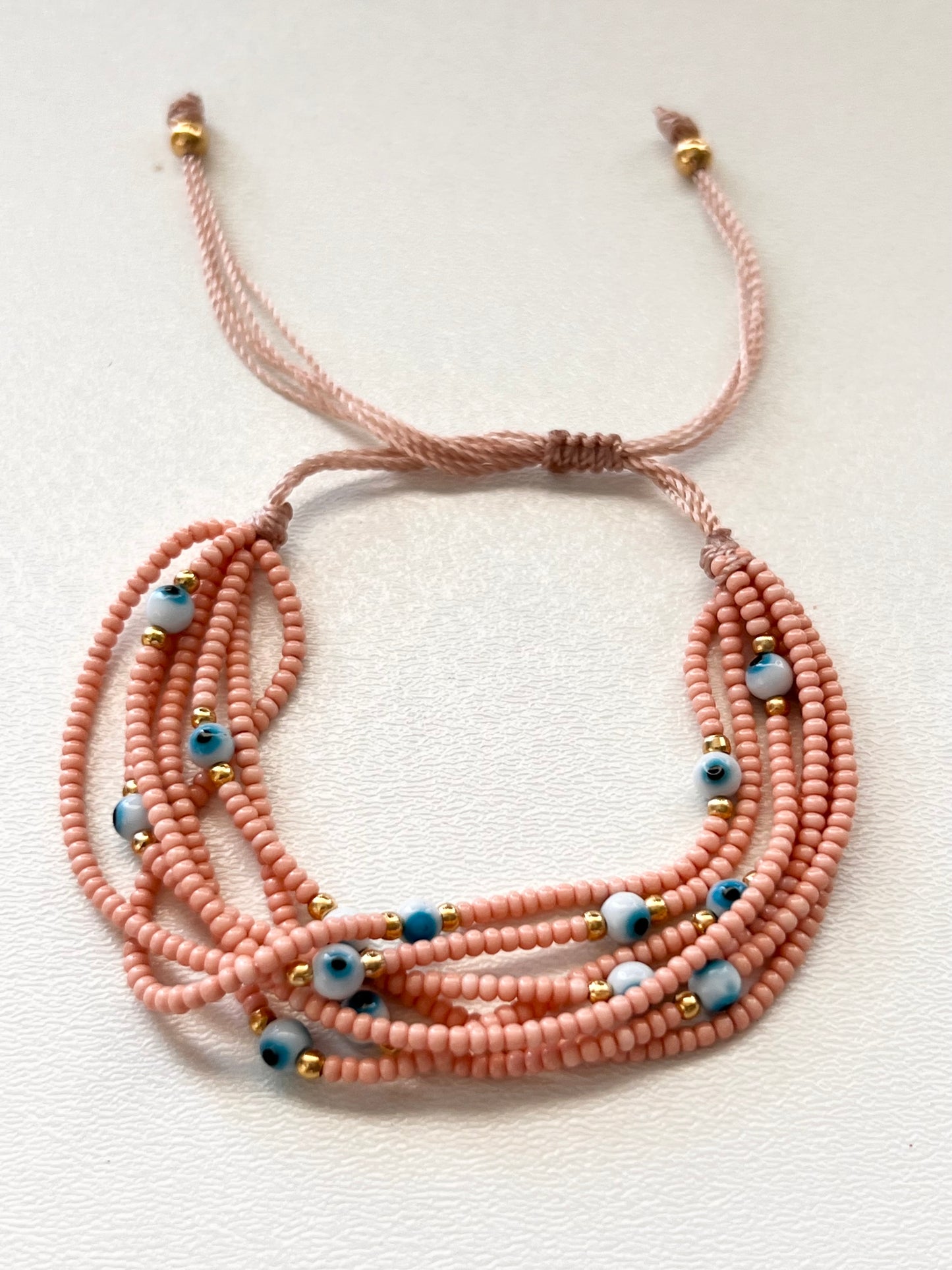 Pulsera de hilo Ojitos / Chapa de Oro 14k